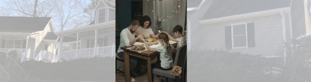 A family of four prays at the dinner table